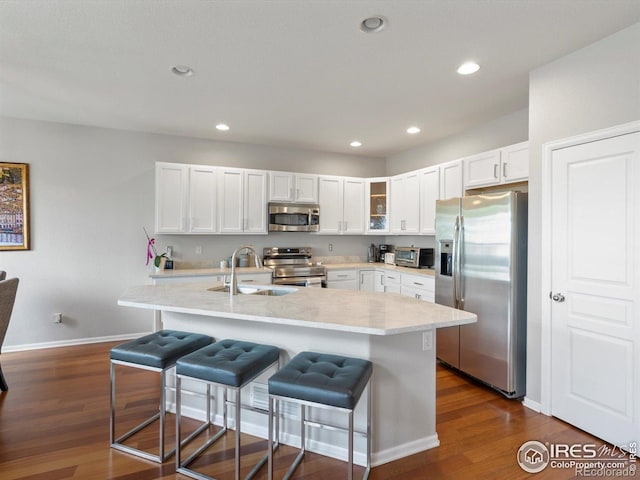 4795 Raven Run, Broomfield, CO 80023 - kitchen featuring appliances with stainless steel finishes, a sink, dark wood-type flooring, light countertops, and recessed lighting