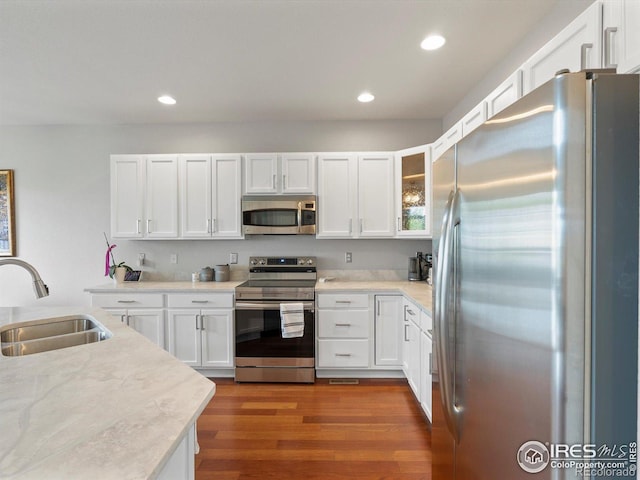 4795 Raven Run, Broomfield, CO 80023 - kitchen featuring stainless steel appliances, a sink, light countertops, white cabinetry, and recessed lighting