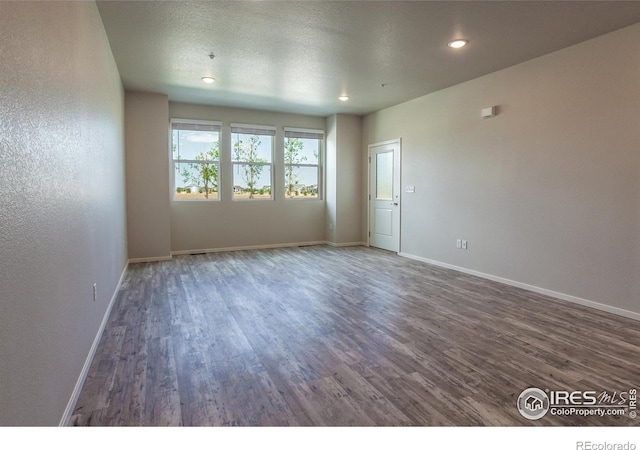 1811 Bounty Dr Unit 4, Windsor, CO 80550 - spare room with wood finished floors, baseboards, and recessed lighting