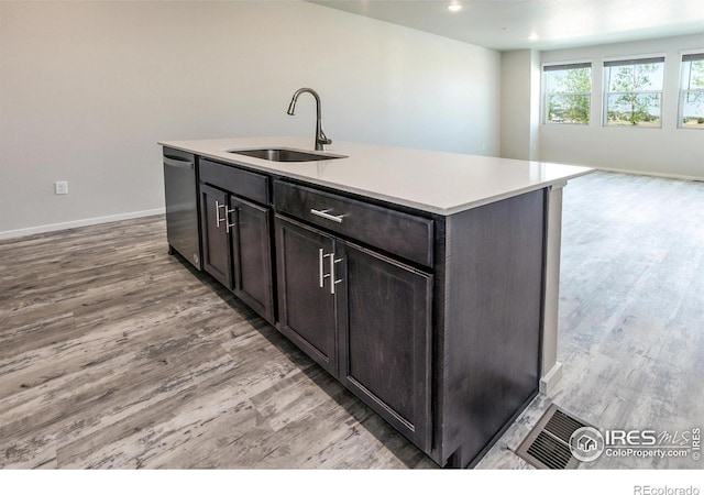 1811 Bounty Dr Unit 4, Windsor, CO 80550 - kitchen featuring a sink, stainless steel dishwasher, light wood-type flooring, light countertops, and open floor plan