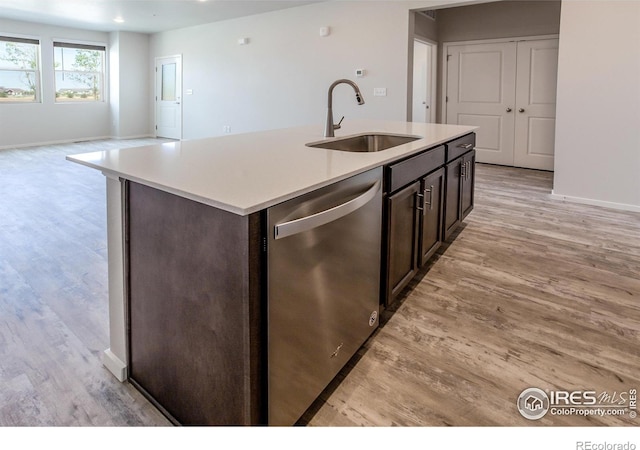 1811 Bounty Dr Unit 4, Windsor, CO 80550 - kitchen with dishwasher, a sink, light wood-type flooring, and light countertops