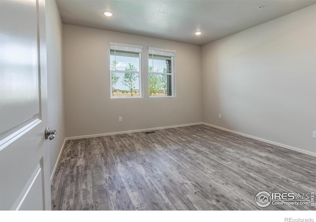 1811 Bounty Dr Unit 4, Windsor, CO 80550 - empty room featuring wood finished floors, baseboards, and recessed lighting