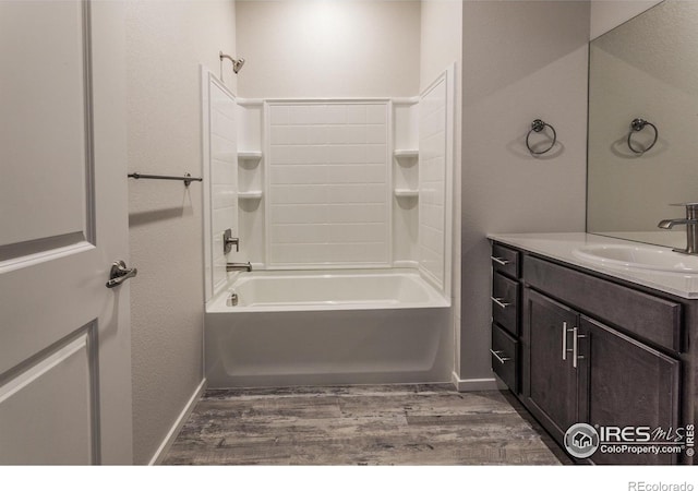1811 Bounty Dr Unit 4, Windsor, CO 80550 - bathroom featuring wood finished floors, vanity, baseboards, and bathing tub / shower combination