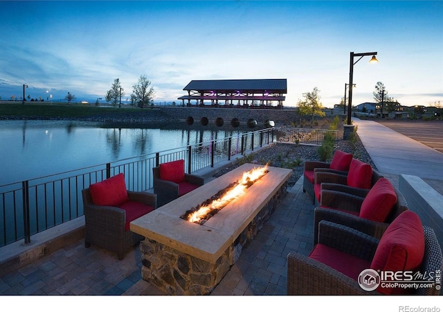 1811 Bounty Dr Unit 4, Windsor, CO 80550 - view of patio / terrace with a fire pit and a water view