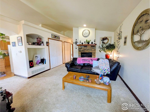 112-114 8th St, Gilcrest, CO 80623 - carpeted living area with lofted ceiling, a stone fireplace, baseboards, and built in features