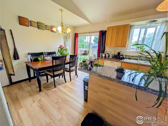 112-114 8th St, Gilcrest, CO 80623 - kitchen featuring lofted ceiling, light wood finished floors, a chandelier, and pendant lighting