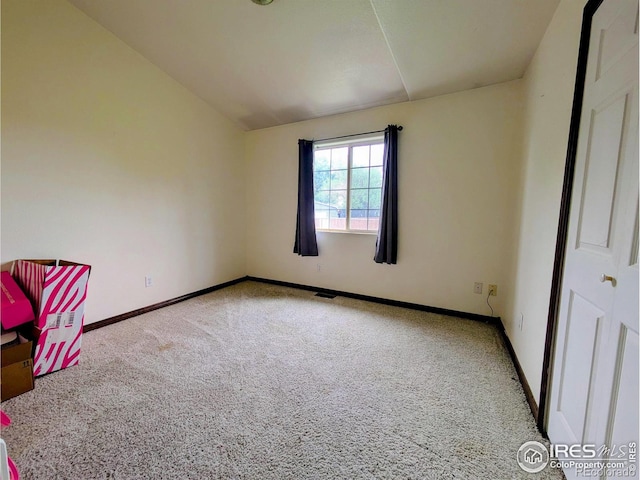 112-114 8th St, Gilcrest, CO 80623 - unfurnished bedroom with carpet flooring, baseboards, and lofted ceiling
