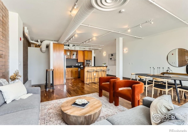 2245 Blake St Unit D, Denver, CO 80205 - living area featuring rail lighting and dark wood-type flooring