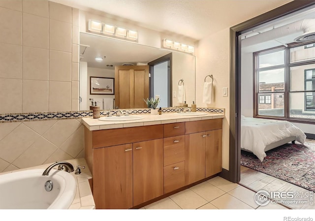 2245 Blake St Unit D, Denver, CO 80205 - bathroom with double vanity, a bath, tile patterned flooring, and connected bathroom