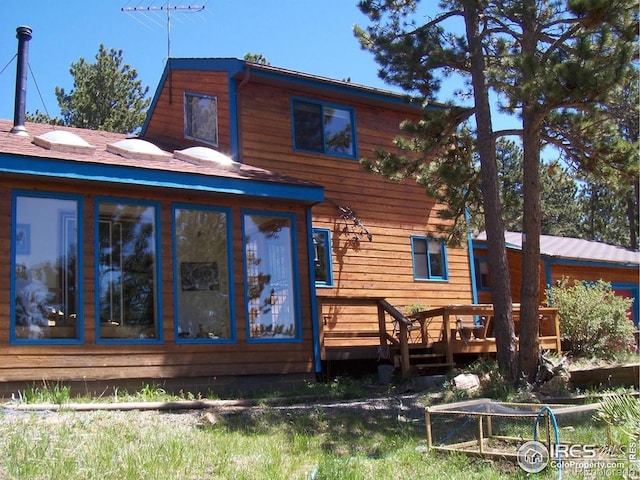 38 Navajo Trl, Nederland, CO 80466 - rear view of house featuring a sunroom and a deck