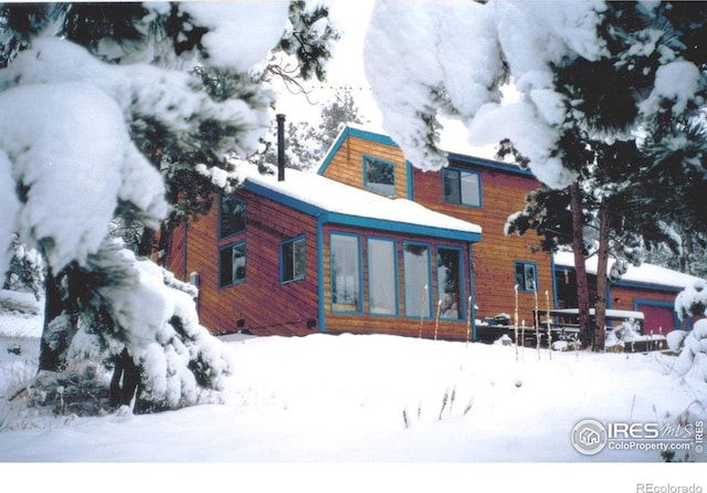 38 Navajo Trl, Nederland, CO 80466 - snow covered house with a sunroom