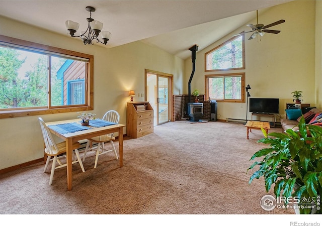 38 Navajo Trl, Nederland, CO 80466 - carpeted dining area with a wood stove, a chandelier, ceiling fan, baseboards, and high vaulted ceiling