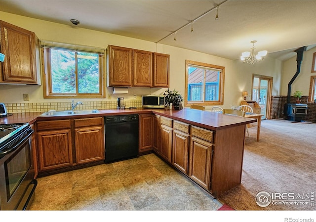 38 Navajo Trl, Nederland, CO 80466 - kitchen with black dishwasher, stainless steel microwave, a sink, electric range, and a wood stove