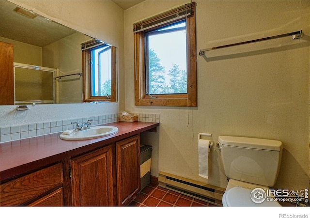 38 Navajo Trl, Nederland, CO 80466 - full bathroom featuring a baseboard heating unit, toilet, vanity, a shower with door, and baseboards