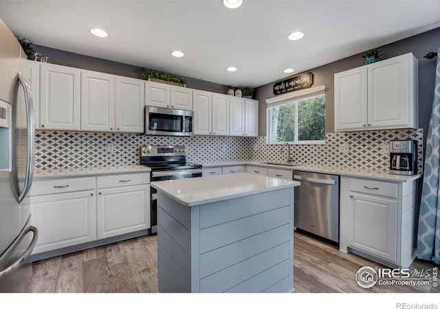5822 Shenandoah Ave, Firestone, CO 80504 - kitchen featuring stainless steel appliances, light wood finished floors, a sink, light countertops, and recessed lighting