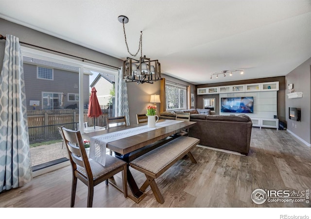 5822 Shenandoah Ave, Firestone, CO 80504 - dining area featuring a chandelier, wood finished floors, and baseboards