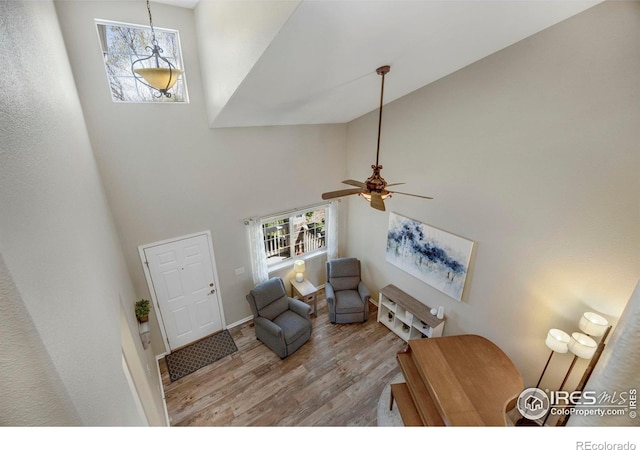5822 Shenandoah Ave, Firestone, CO 80504 - entrance foyer with a high ceiling, wood finished floors, healthy amount of natural light, a ceiling fan, and baseboards
