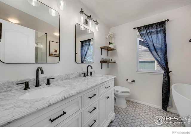 5822 Shenandoah Ave, Firestone, CO 80504 - full bath with tile patterned floors, double vanity, a freestanding tub, an enclosed shower, and toilet