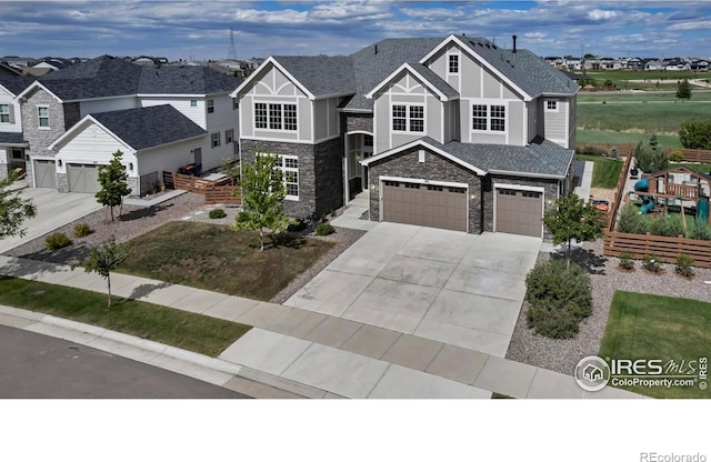913 Green Mountain Dr, Erie, CO 80516 - view of front of home featuring stone siding, concrete driveway, a garage, a residential view, and a shingled roof