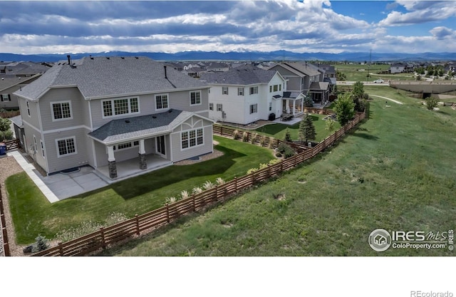 913 Green Mountain Dr, Erie, CO 80516 - rear view of house featuring a patio area, roof with shingles, a mountain view, and a residential view