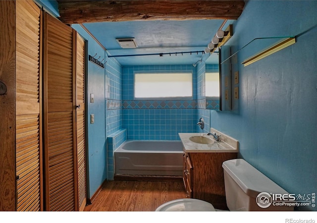 545 Eldorado Ave, Nederland, CO 80466 - bathroom with toilet, wood finished floors, vanity, and a tub to relax in