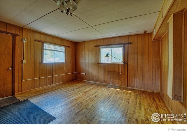 545 Eldorado Ave, Nederland, CO 80466 - empty room with hardwood / wood-style floors, healthy amount of natural light, and wood walls