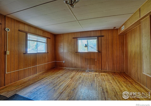 545 Eldorado Ave, Nederland, CO 80466 - unfurnished room with wood-type flooring and wooden walls