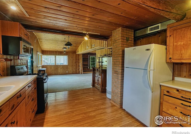 545 Eldorado Ave, Nederland, CO 80466 - kitchen with freestanding refrigerator, gas stove, wood ceiling, wood walls, and light wood-style flooring