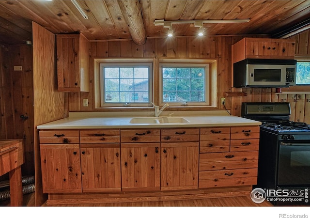 545 Eldorado Ave, Nederland, CO 80466 - kitchen with stainless steel microwave, black range with gas cooktop, a sink, wood ceiling, and track lighting