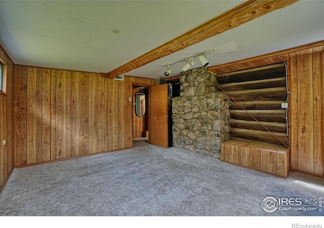 545 Eldorado Ave, Nederland, CO 80466 - unfurnished living room featuring carpet, wooden walls, and beam ceiling