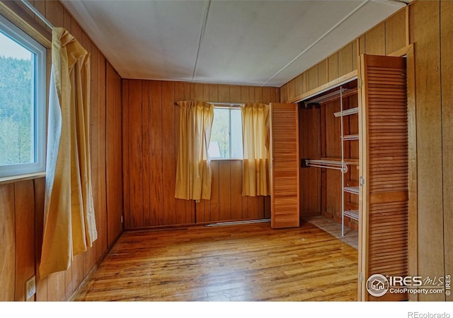 545 Eldorado Ave, Nederland, CO 80466 - unfurnished bedroom featuring wood finished floors, wooden walls, and a closet