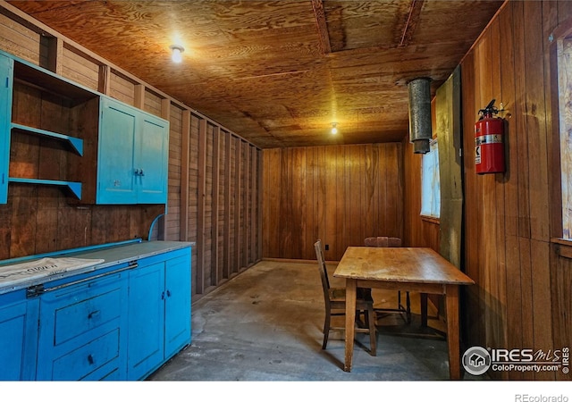 545 Eldorado Ave, Nederland, CO 80466 - dining room featuring wood walls, unfinished concrete floors, and wood ceiling
