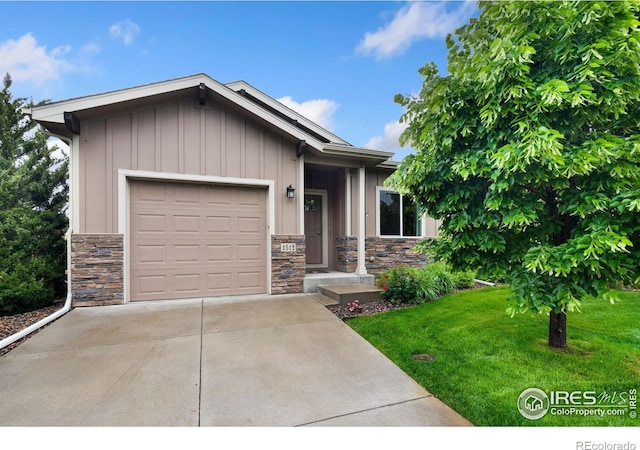 1512 Snowy Range Ct, Loveland, CO 80538 - view of front of house with stone siding, board and batten siding, a garage, a front yard, and driveway