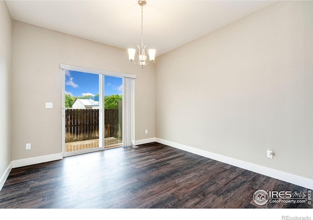 1512 Snowy Range Ct, Loveland, CO 80538 - empty room featuring a chandelier, dark wood finished floors, and baseboards