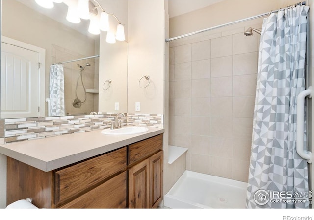 1512 Snowy Range Ct, Loveland, CO 80538 - bathroom featuring vanity, tiled shower, and backsplash