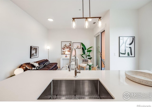 2876 W 53rd Ave Unit 301, Denver, CO 80221 - detailed view of a sink, pendant lighting, light countertops, and recessed lighting
