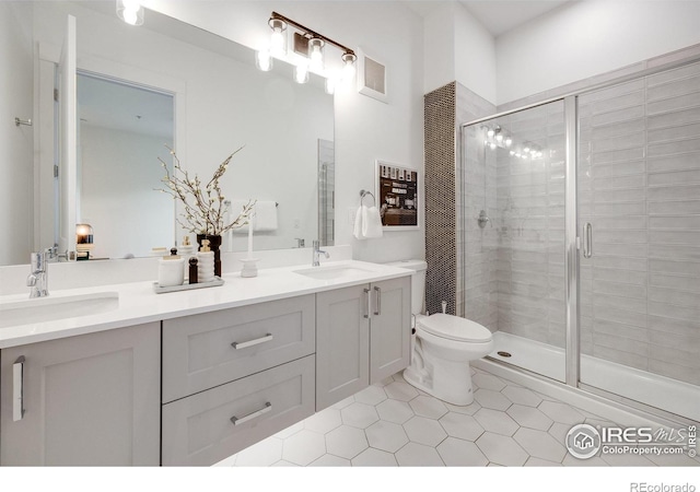 2876 W 53rd Ave Unit 301, Denver, CO 80221 - full bath with double vanity, a stall shower, tile patterned flooring, and toilet
