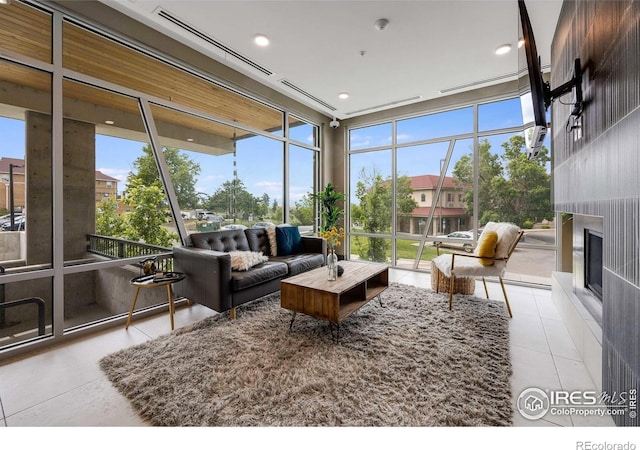 2876 W 53rd Ave Unit 301, Denver, CO 80221 - tiled living room featuring a wall of windows, plenty of natural light, a glass covered fireplace, and recessed lighting
