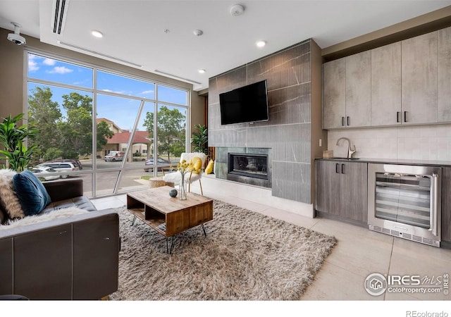 2876 W 53rd Ave Unit 301, Denver, CO 80221 - living room with beverage cooler, light tile patterned flooring, a high end fireplace, recessed lighting, and bar