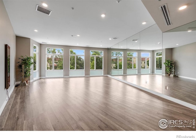 2876 W 53rd Ave Unit 301, Denver, CO 80221 - exercise room featuring plenty of natural light, wood finished floors, baseboards, and recessed lighting