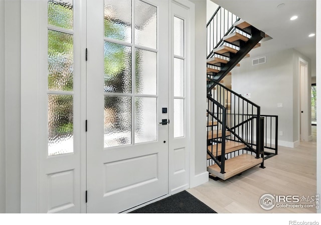 2860 Table Mesa Dr, Boulder, CO 80305 - entryway featuring light wood-style flooring, stairway, baseboards, and recessed lighting