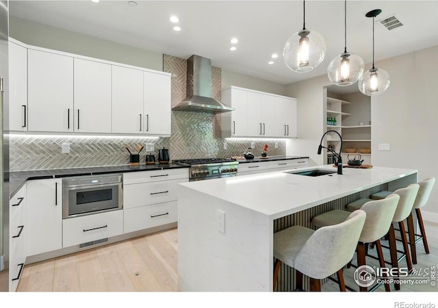 2860 Table Mesa Dr, Boulder, CO 80305 - kitchen with wall chimney exhaust hood, a sink, recessed lighting, stainless steel appliances, and decorative backsplash