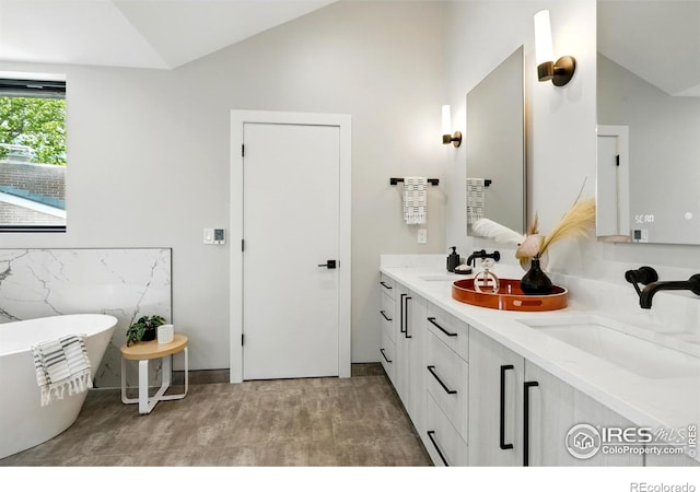 2860 Table Mesa Dr, Boulder, CO 80305 - bathroom featuring lofted ceiling, double vanity, and a freestanding tub