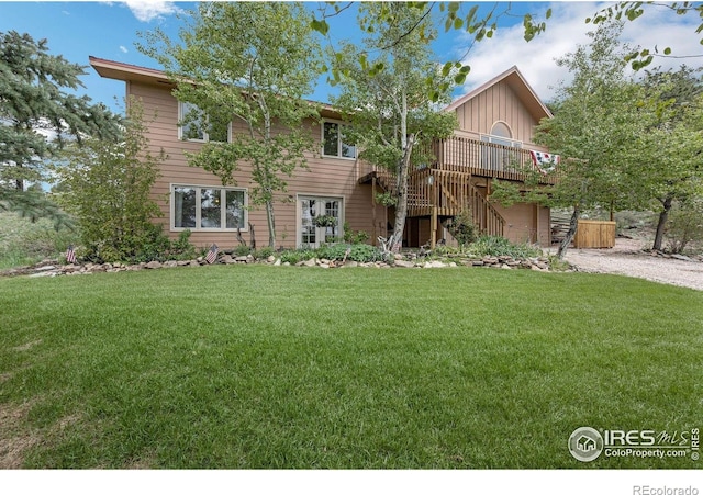 17284 W County Road 74e, Red Feather Lakes, CO 80545 - view of front of house with stairs, a deck, a front lawn, and board and batten siding