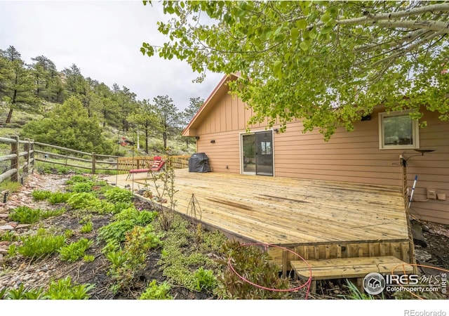 17284 W County Road 74e, Red Feather Lakes, CO 80545 - wooden deck with a grill