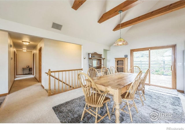 17284 W County Road 74e, Red Feather Lakes, CO 80545 - dining space with beam ceiling, light colored carpet, high vaulted ceiling, and baseboards