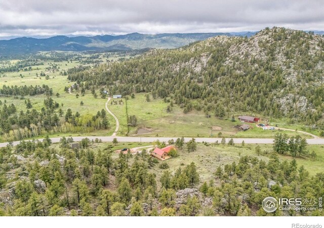 17284 W County Road 74e, Red Feather Lakes, CO 80545 - aerial overview of property's location with a mountain backdrop and a heavily wooded area