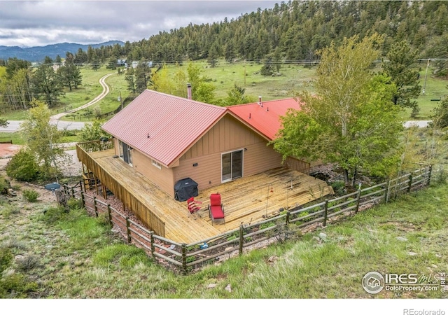 17284 W County Road 74e, Red Feather Lakes, CO 80545 - back of property with a view of trees, metal roof, and a deck with mountain view