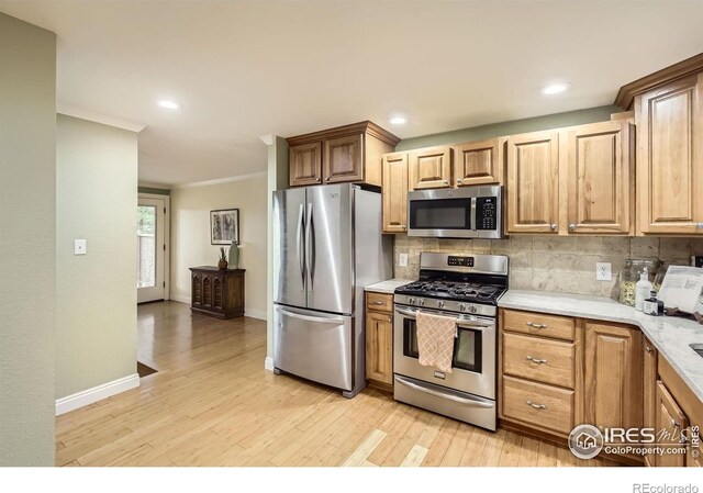 1510 22nd Ave, Longmont, CO 80501 - kitchen with stainless steel appliances, light wood-type flooring, tasteful backsplash, baseboards, and recessed lighting