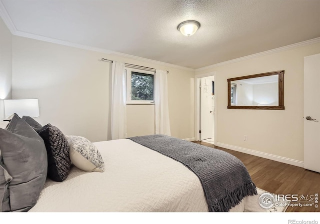 1510 22nd Ave, Longmont, CO 80501 - bedroom with wood finished floors, crown molding, baseboards, and a textured ceiling
